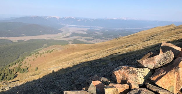 Looking out over wind break on Colorado trail taking a break from hiking