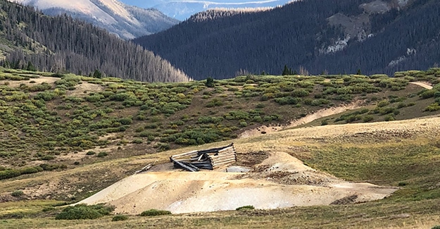 Piles of mining tailings around cabin