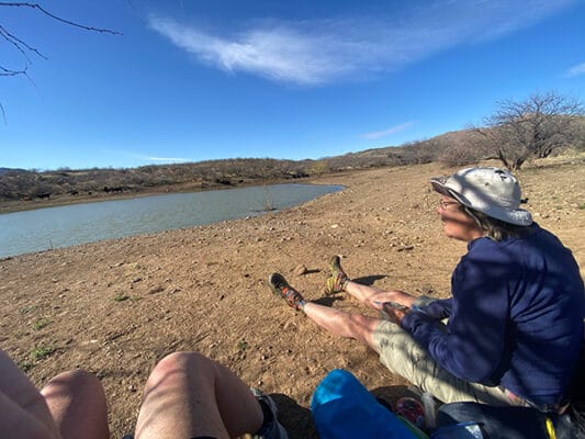 Average Hiker watching cows with Cricket at a cow tank.