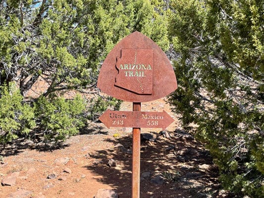 Arizona Trail sign listing miles to both borders