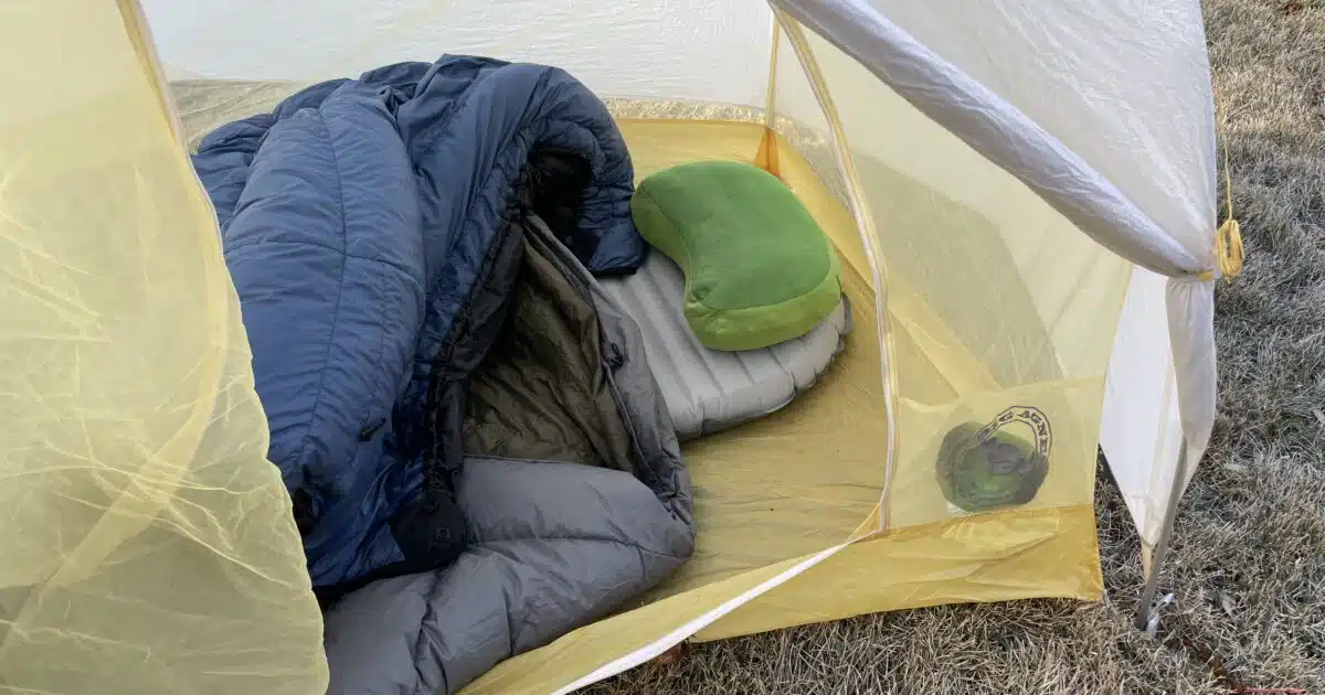 Interior of tent with quilt, pad and pillow.